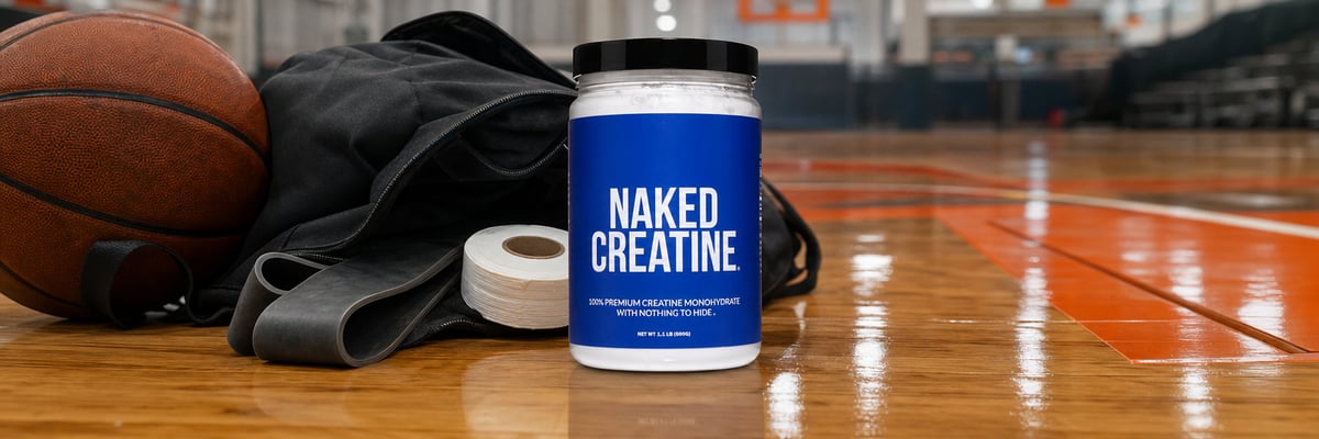 Naked Creatine tub on basketball court sideline beside athletic bag and basketball