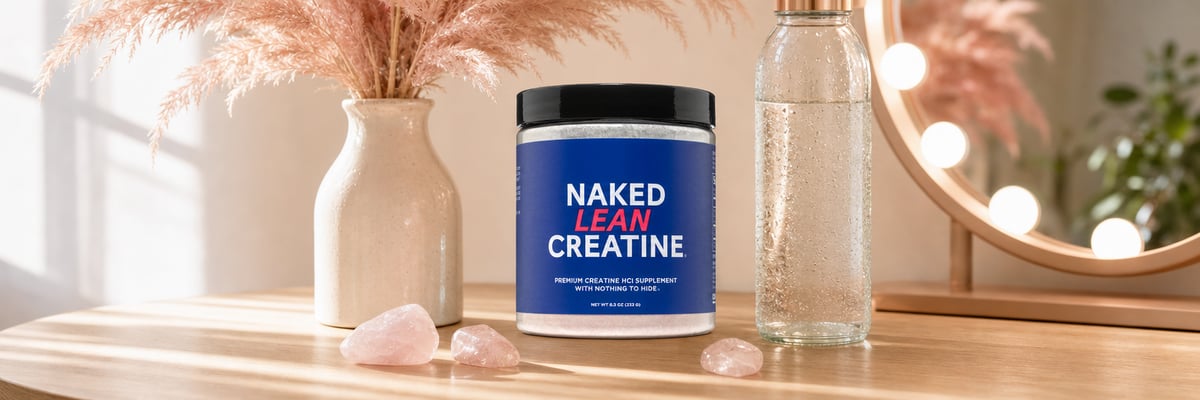 Naked Lean Creatine tub on oak vanity desk with pampas grass, rose quartz, and water bottle