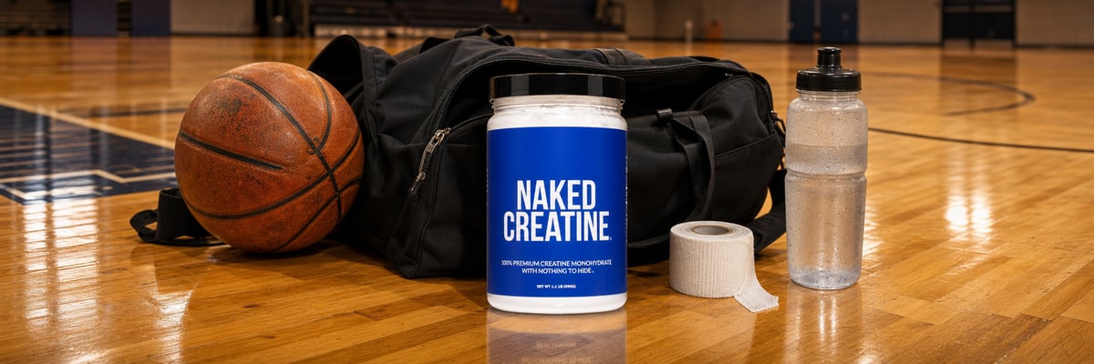 Naked Creatine tub on basketball court sideline beside athletic bag and basketball